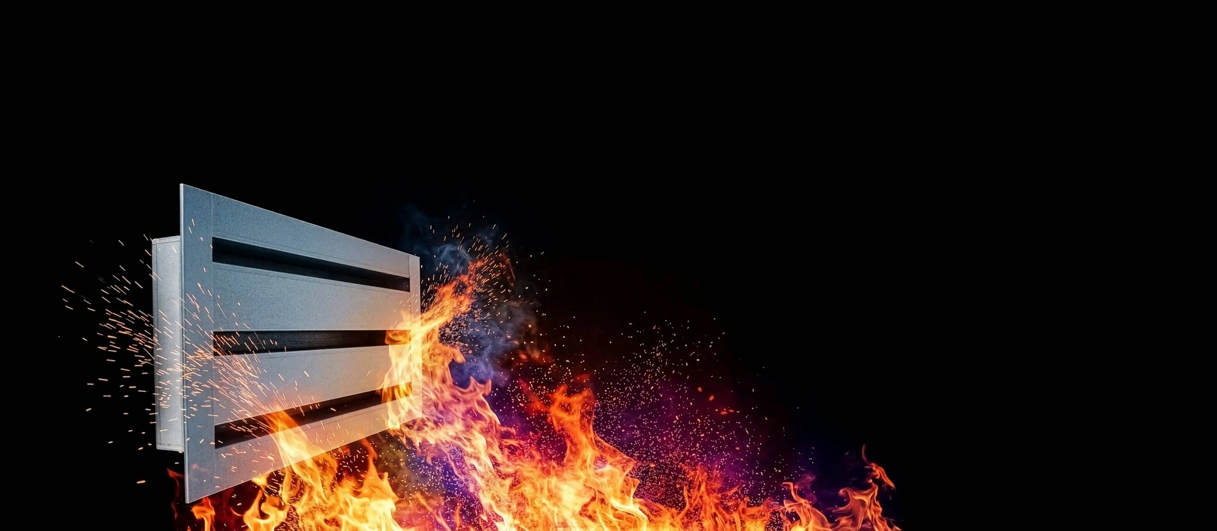 Modern range hood engulfed in flames against a black background.