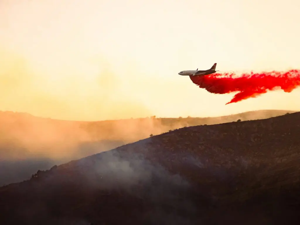 Plane releasing chemical to extinguisher wildfire in Saratoga Springs, Utah.