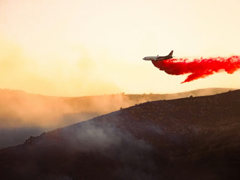 Plane releasing chemical to extinguisher wildfire in Saratoga Springs, Utah.